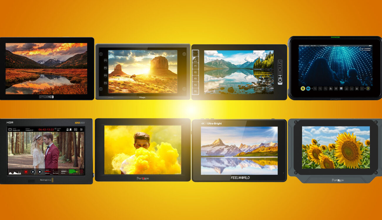multiple bright monitors with bright sun in the background